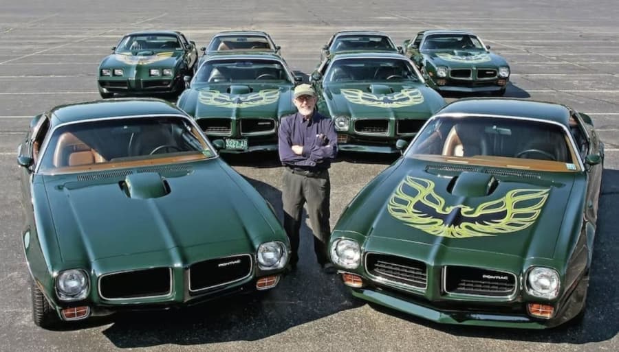 Bill Porter standing with 1970s Firebird models RESIZED 4