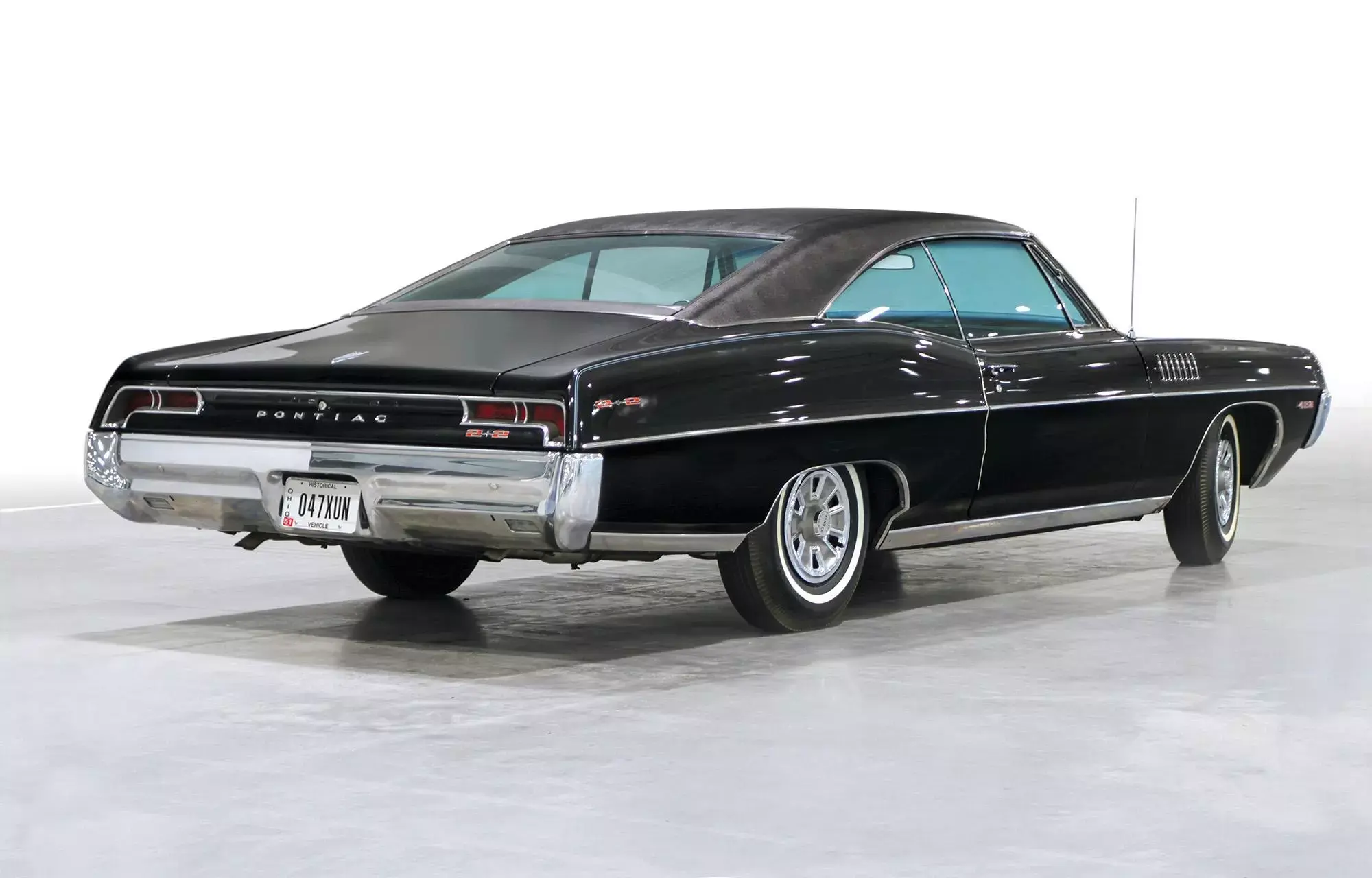 Color image of a 1967 pontiac catalina 2 2 parked indoors on a garage floor rear 3 4 position jpg