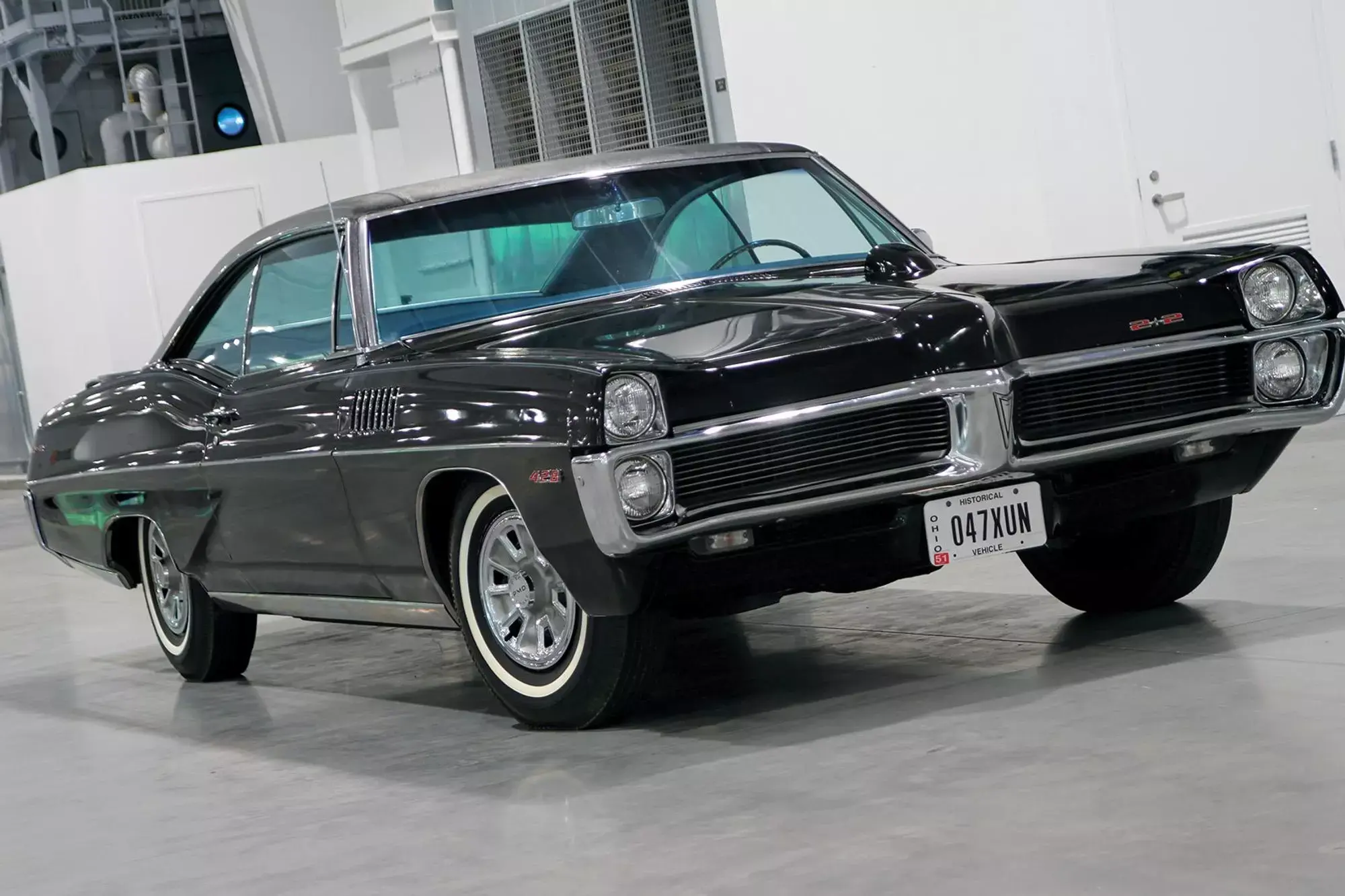 Color image of a 1967 pontiac catalina 2 2 parked on the floor indoors at a front 3 4 position jpg